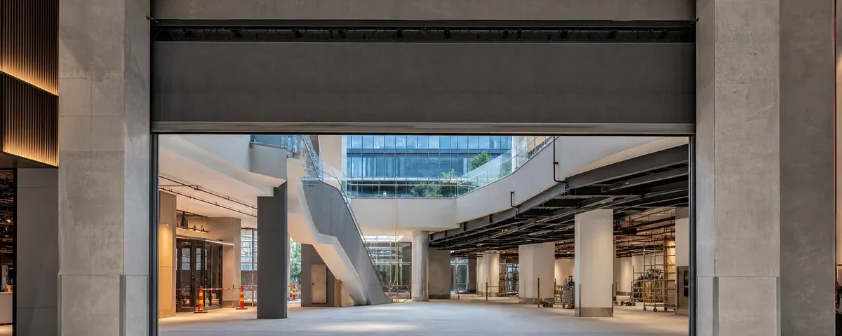 Active fire curtain coordinated into a wide mixed-use atrium opening