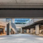 Active fire curtain coordinated into a wide mixed-use atrium opening