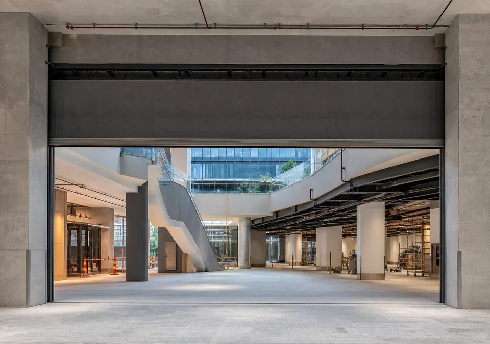 Active fire curtain coordinated into a wide mixed-use atrium opening